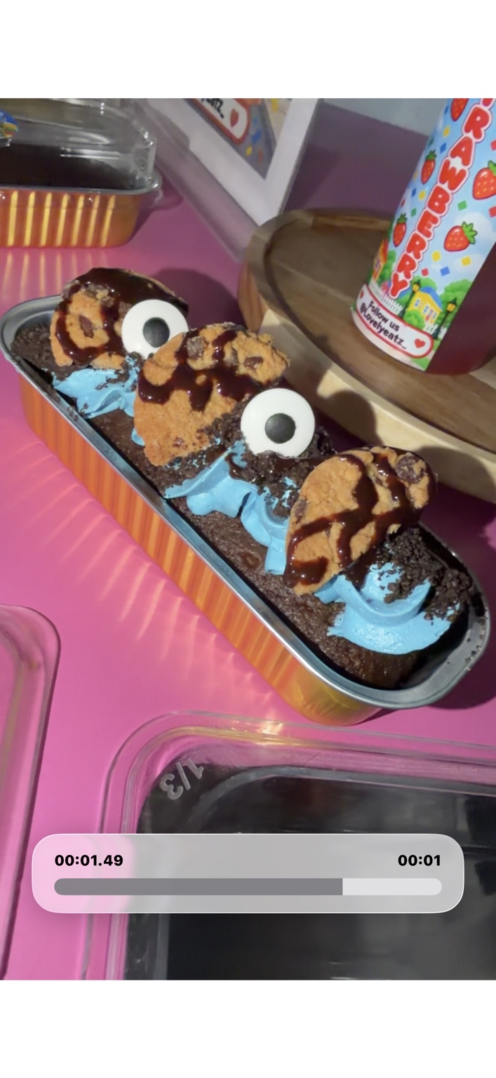 Chocolate desserts with blue frosting, cookie decorations, and chocolate drizzle on the LovelyEatz cart